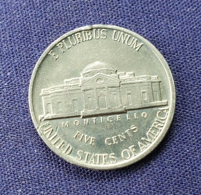 2009 Jefferson Nickel with off-center strike error showing design shifted off planchet center with blank area visible