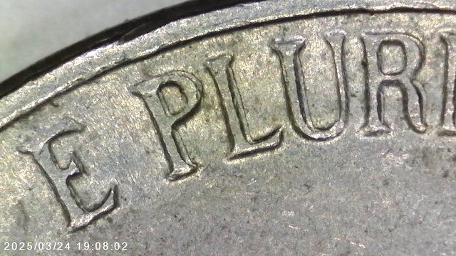 Close-up of 2009 Jefferson Nickel doubled die error showing doubling on LIBERTY inscription with visible shelf separation