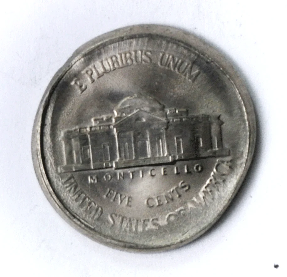 2009 Jefferson Nickel broadstrike error showing coin struck outside collar resulting in wider planchet with no edge reeding